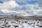 Russia. Magadan Region. Beautiful Lake Momontay against the backdrop of a snowy mountain range.