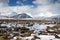 Russia. Magadan Region. Beautiful Lake Momontay against the backdrop of a snowy mountain range.