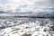 Russia. Magadan Region. Beautiful Lake Momontay against the backdrop of a snowy mountain range.