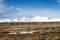 Russia. Magadan Region. Beautiful Lake Momontay against the backdrop of a snowy mountain range.