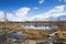 Russia. Magadan Region. Beautiful Lake Momontay against the backdrop of a snowy mountain range.