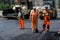 Russia, Magnitogorsk, August 15, 2019. Men in orange uniform are laying hot asphalt on one of the city streets. Road repair