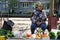 Russia, Magnitogorsk, August 6, 2019. Street trading in the city. An elderly woman sells vegetables grown in a private household