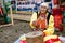 Russia, Magnitogorsk, - June, 15, 2019. An elderly woman demonstrates the work of the old wooden manual millstone during the
