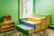 Russia, Moscow, 02.01.2019: Rest in a public kindergarten. Many beds in the bedroom. Empty room with green walls