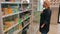 Russia, Moscow, 09/10/2020. A blonde woman in a protective medical mask in a pandemic makes purchases in a grocery store. A woman