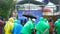 Russia - Moscow, 10.20.2019: group of people wearing colorful and standing outside in the rainy weather. Art. Team of