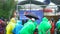 Russia - Moscow, 10.20.2019: group of people wearing colorful and standing outside in the rainy weather. Art. Team of