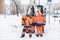 Russia Moscow 13.02.2021 Street cleaners,men clean snow from road,sidewalk with large shovels.Tractor,snow removal