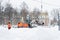 Russia Moscow 13.02.2021 Street cleaners,men clean snow from road,sidewalk with large shovels.Tractor,snow removal