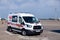 Russia Moscow 2019-06-17 Ford ambulance car on the background of the airport runway, large bus for transportation and transfer of
