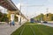 Russia, Moscow: Rails covered with lawn grass on rails, Pedestrians, tram