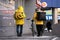 Russia, Naberezhnye Chelny, March 9, 2021: food delivery men in yellow jackets with thermos bags on their backs on a city street