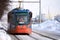 Russia, Naberezhnye Chelny, March 9, 2021: a tram rides on a snow-covered street. A woman in a medical mask is driving the tram. C