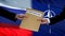 Russia and NATO officials exchanging confidential envelope, flags background