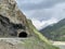 Russia, North Ossetia. Tunnel in Kassar gorge in summer in cloudy weather