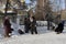 Russia, Novosibirsk, February 23, 2019: poorly dressed unemployed women pensioners beggars begging and money near the Church alms