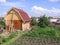 Russia, Novosibirsk, wooden house made of logs with a vegetable garden on a plot of land in the Siberian village