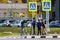 Russia - October 2019: A group of children on Kick scooter at a pedestrian crossing over a highway