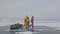 Russia, Olkhon - February 28, 2018: Group of tourists with ice sleds walking along the ice of Lake Baikal. Travel woman