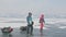 RUSSIA, OLKHON - FEBRUARY 28, 2018: Group of tourists with ice sleds walking along the ice of Lake Baikal. Travel woman