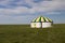 Russia. One traditional Kalmyk or Mongol yurts in a green spring steppe under the blue sky