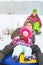 Russia, Ryazan 05 Jan 2019: happy man with his family sliding down hill on snow tubes over winter natural background