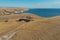 Russia, Saratov - 15, September. Aerial view of young fitness people trail runner running on top of grassland mountain.