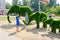 Russia Saratov region August 28, 2018: sculptures green elephants from the lawn people are photographed near them