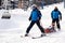 Russia, Sheregesh 2018.11.17 The lifesavers on skis carry a skier who has crashed of tree, with broken bandaged leg in the cradle