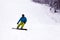 Russia, Sheregesh 2018.11.18 Professional man snowboarder in bright sportswear and outfit skiing downhill in snowy sunny high