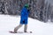 Russia, Sheregesh 2018.11.18 Professional man snowboarder in bright sportswear and outfit skiing downhill in snowy sunny high