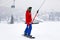Russia, Sheregesh 2018.11.18 Snowboarder in professional outfit climb up ski lift up a mountains. Concept safety skiing, outdoo