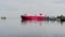 Russia, St. Petersburg, 18 June 2021: The huge ferry with trucks moves on a waterway leaving the city, red color, the