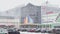 Russia, St.Petersburg, 18 March 2021: Heavy snowfall in city bustle, an automobile parking at huge shopping center, a