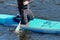 RUSSIA, ST.PETERSBURG - August 8, 2020: Surfer on his knees in ammunition on a board floats