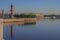 Russia, St. Petersburg, bright cloudless summer on the spit of Vasilievsky Island. Red Rostral columns, blue sky, blue water of th