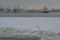Russia, St. Petersburg, cloudy snowy winter day, the Neva River in the snow, port, ships, shipyards.