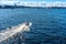 Russia, St. Petersburg, July 2020. Speedboat wake and ships on the river channel in the city center.