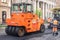 RUSSIA, ST.PETERSBURG - MAY 12, 2019: Repair of roads. Two orange asphalt pavers and workers in coveralls