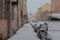 Russia, St. Petersburg, a narrow winter street, characteristic of St. Petersburg. A lot of snow, a number of cars, expressive arch