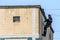 Russia, St. Petersburg, September 2020. Workers on the roof of a multi-storey residential building.