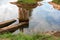 Russia, Staraya Russa, August 2021. A pond with mineral water and the ruins of a wooden bath.