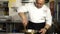 RUSSIA, TOGLIATTI - NOVEMBER 12, 2018: Chef prepares a pumpkin dish, mixing the pieces in a plate with a spoon