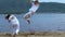 Russia, Togliatty - July 11, 2018: Man and woman train capoeira on the beach - concept about people
