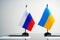 Russia and Ukraine flags on negotiation table close up