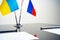 Russia and Ukraine flags on negotiation table close up