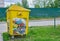 Russia, Vladimir, 02.06.2021, Yellow container for household garbage filled with garbage stands on the street.