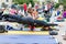 Russia, Vladivostok, 06/18/2016. Man does gymnastic exercise `stand on one hand` on the ground on yoga open training.