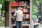 Russia, Vladivostok, 07/06/2019. A man stands by the wooden street cabinet with free books. Books in the cabinet are free, anyone